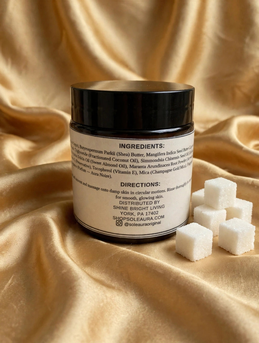 Solé Aura Whipped Sugar Scrub — Aura Noire, back label with ingredients and directions, gold silk background with sugar cubes